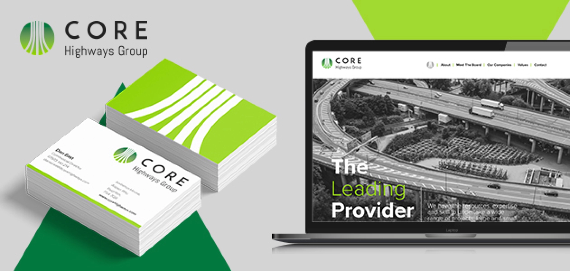 A laptop screen showing the new website design for Core Highways Group and a pile of business cards showing the new branding and logo Fabrick's creative team designed